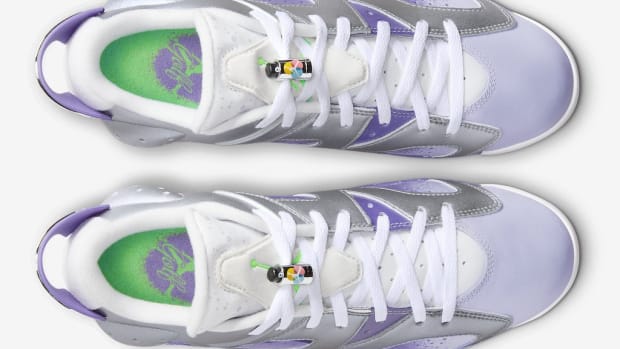 Overview of purple and grey Air Jordan golf shoes.